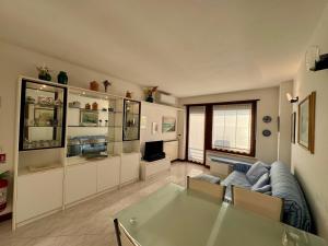 a living room with a couch and a glass table at Villa Luciana in Grado