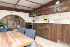 a kitchen with a wooden table and blue chairs at HakanBey Konağı in Mardin