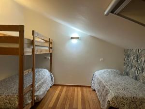 a bedroom with two bunk beds in a room at Pousada RIO CALDO in Rio Caldo +42 photos