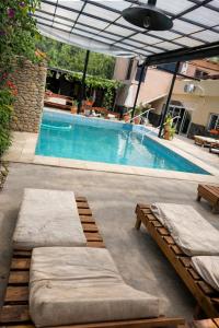 a swimming pool with two mattresses on a patio at Hotel Sante in Tinogasta