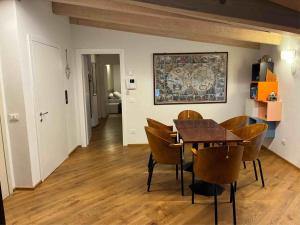 a dining room with a table and chairs at Respiro di lago in Molveno