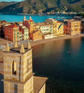 a group of buildings on a beach with water at DIMORA della TORRE a due passi dal mare in Sestri Levante