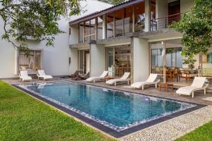 an exterior view of a house with a swimming pool at ONA Garden Villa in Galle