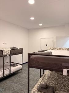 a room with two bunk beds and a rug at LITTLE Hostel in Puerto de Sagunto