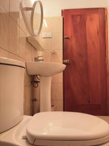 a bathroom with a toilet and a sink at Fairview Villa in Hikkaduwa