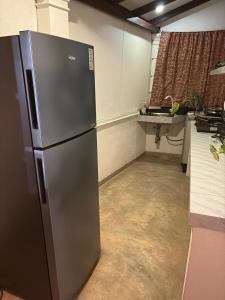 a kitchen with a stainless steel refrigerator in a room at Fairview Villa in Hikkaduwa +12 photos
