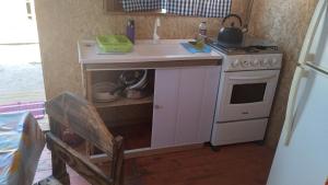 a small kitchen with a sink and a stove at El Refugio in Santa Vitória do Palmar +2 photos