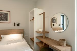 a bedroom with a bed and a mirror at Deux Olives Luxury Villa in Maleme +19 photos