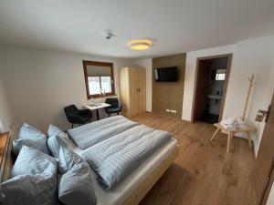 a bedroom with a bed and a living room at Das Fränkische Reichenbach in Reichenbach