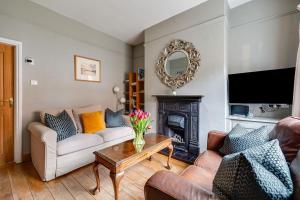 a living room with two couches and a fireplace at Gamul Place - Quiet City Centre in Chester