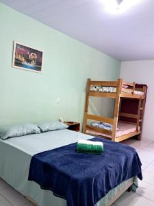 a bedroom with a bed with a blue blanket and a ladder at Aguapé quarto 3 in Barreirinhas