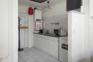 a kitchen with a sink and a microwave at Zaras Studio Hermes in Zandvoort