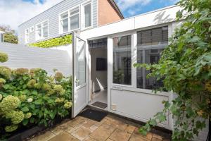 an extension to a house with a white door at Zaras Studio Hermes in Zandvoort