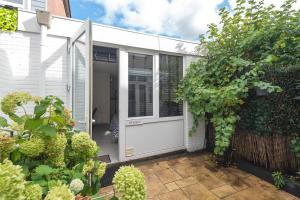 an extension to a house with a white door at Zaras Studio Hermes in Zandvoort