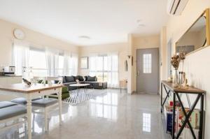 a living room with a couch and a table at וילה קלמה מגדל in Migdal