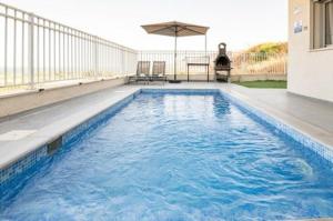 a swimming pool with blue water in a house at וילה קלמה מגדל in Migdal
