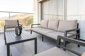 a living room with a couch and a table at וילה קלמה מגדל in Migdal