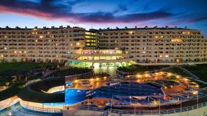 a large building with a courtyard in front of it at Hotel Apartamento Paraiso De Albufeira in Albufeira
