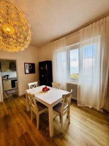 a dining room with a table and chairs and a window at Casa Maggiana in Mandello del Lario +7 photos