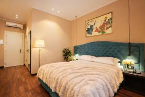 a bedroom with a large bed with a green headboard at Hotel Ristorante Ala d'Oro in Lugo +139 photos