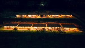 a house lit up at night with lights at Tara Vegan Lodge - Sacred Valley in Urubamba