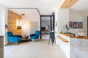 a living room with blue chairs and a table at Hotel Magnolie GmbH in Laufenburg