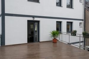 a balcony of a building with a door and a plant at Luani appartments in Krefeld