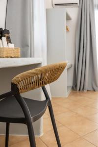 a chair sitting in front of a desk at Olive Garden Hotel in Agios Prokopios +94 photos