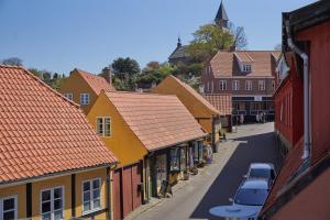 a view of a street in a town with buildings at Klippen Hotel - Therns in Gudhjem