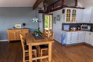 a kitchen with a wooden table and a kitchen with white cabinets at OGO827-Vreta-Kloster-Sjoebacka-17 in Vreta Kloster +21 photos