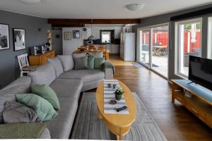 a living room with a couch and a table at OGO827-Vreta-Kloster-Sjoebacka-17 in Vreta Kloster