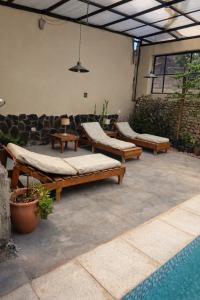 a patio with couches and a swimming pool at Hotel Sante in Tinogasta