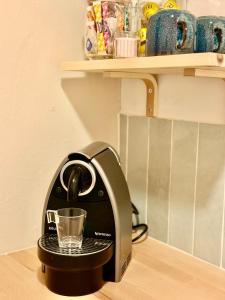 a coffee maker on a counter with a glass at Charmant studio cosy - hypercentre Capitole in Toulouse