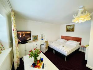 a hotel room with two beds and a flat screen tv at K&B Residence in Jarosław