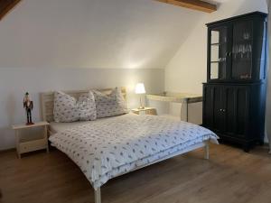 a bedroom with a bed and a black cabinet at Apartmán Monarchia in Banská Štiavnica
