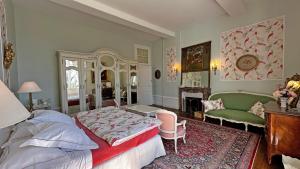 a bedroom with a bed and a green couch at Château de la Chabroulie in Isle +54 photos