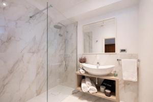 a bathroom with a sink and a shower at Hotel Ristorante Ala d'Oro in Lugo