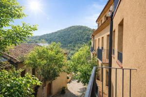 an alley with buildings and a mountain in the background at Apartament amb vistes al castell - Cal Martí in Montsonis