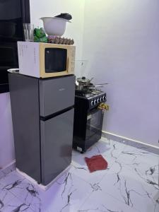 a kitchen with a microwave on top of a stove at JJ home in Amdalai +2 photos