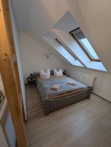 a bedroom with a bed in a attic at Ferienwohnung Naturparadies Gnitz in Lütow
