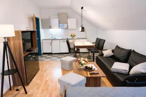 a living room with a couch and a table at Appartementhaus Sonnenschein - 250m zum Strand im Zentrum von Binz in Binz