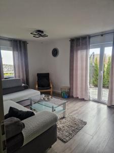 a living room with a couch and a glass table at Ferienwohnung in Olpe-Rhode am Biggesee in Olpe