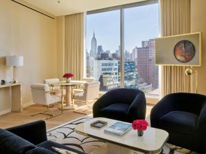 a living room with a view of a city at Faena New York in New York