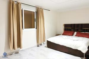 a bedroom with a bed and a large window at Perlivia in Chefchaouen