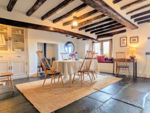 a dining room with a table and chairs at Wayside Cottage 1637 in Millom +24 photos