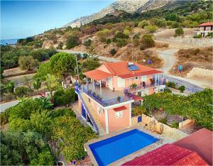 an aerial view of a house with a swimming pool at Moulinos Cottages Kefalonia in Kardhakáta