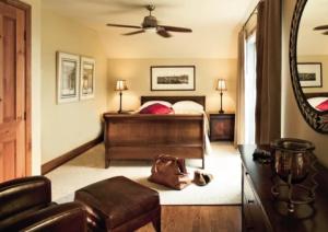 a bedroom with a bed and a mirror at Cap Tremblant in Mont-Tremblant