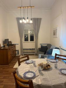 a living room with a table and a couch at Casa do Avô in Sacavém +17 photos