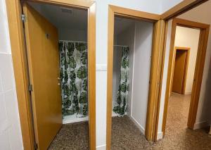 a hallway with two glass doors with plants on them at Hostel valencia ruzafa in Valencia +4 photos