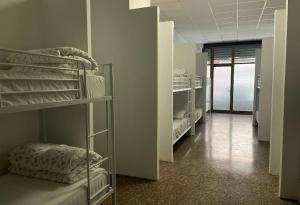 a row of bunk beds in a room at Hostel valencia ruzafa in Valencia